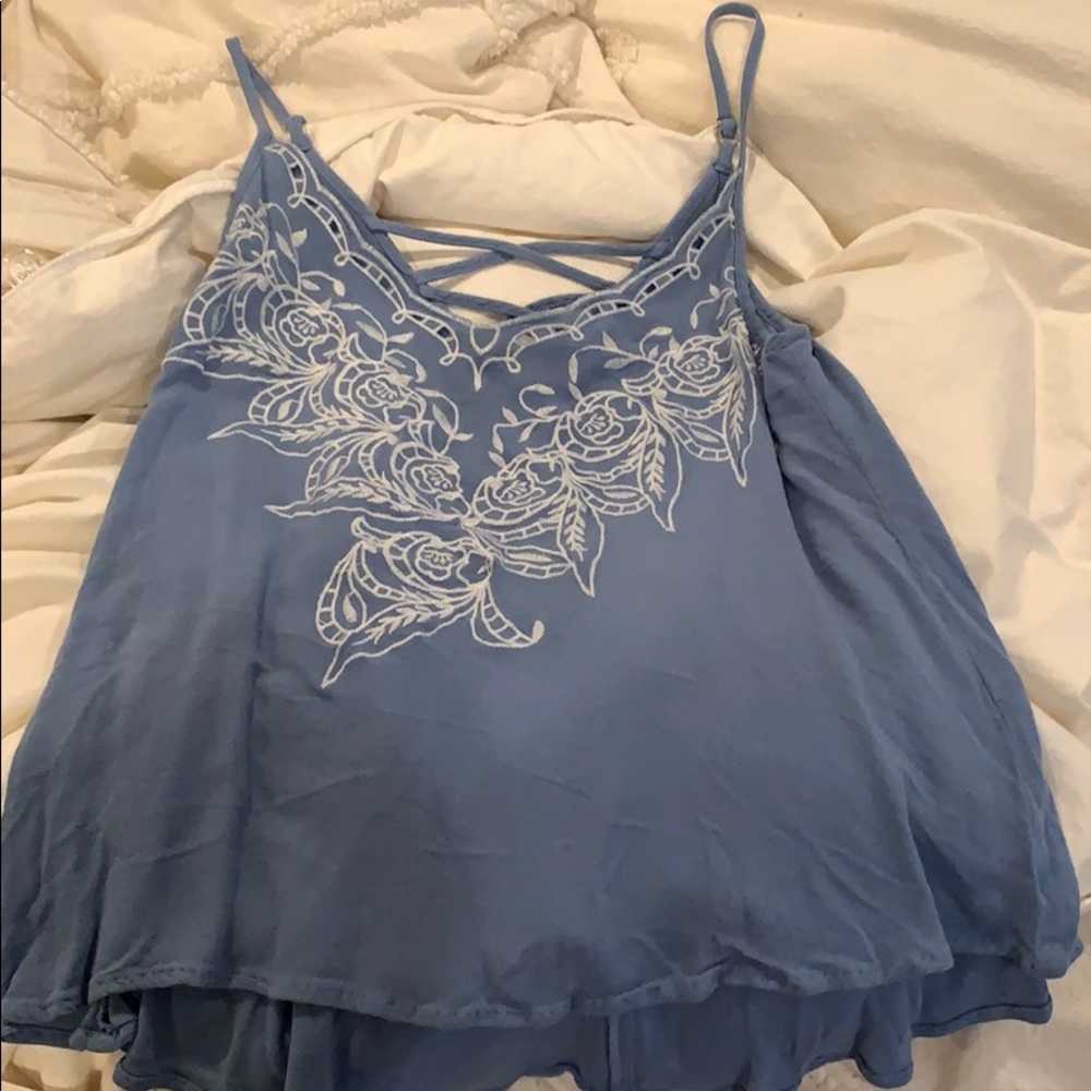 blue tank top with white flower embroidery